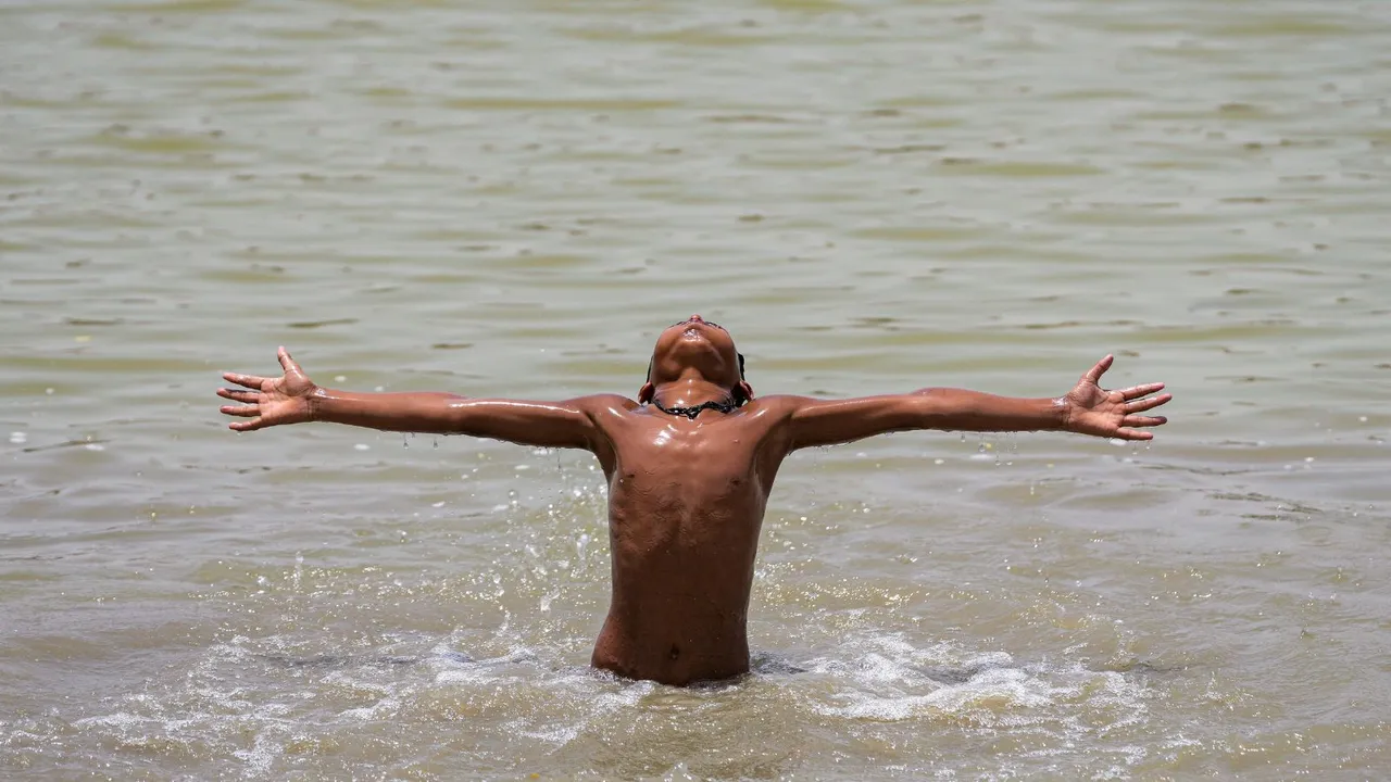 Child play at a water pond to cool themselves as temperature soars in New Delhi, Wednesday, May 29, 2024