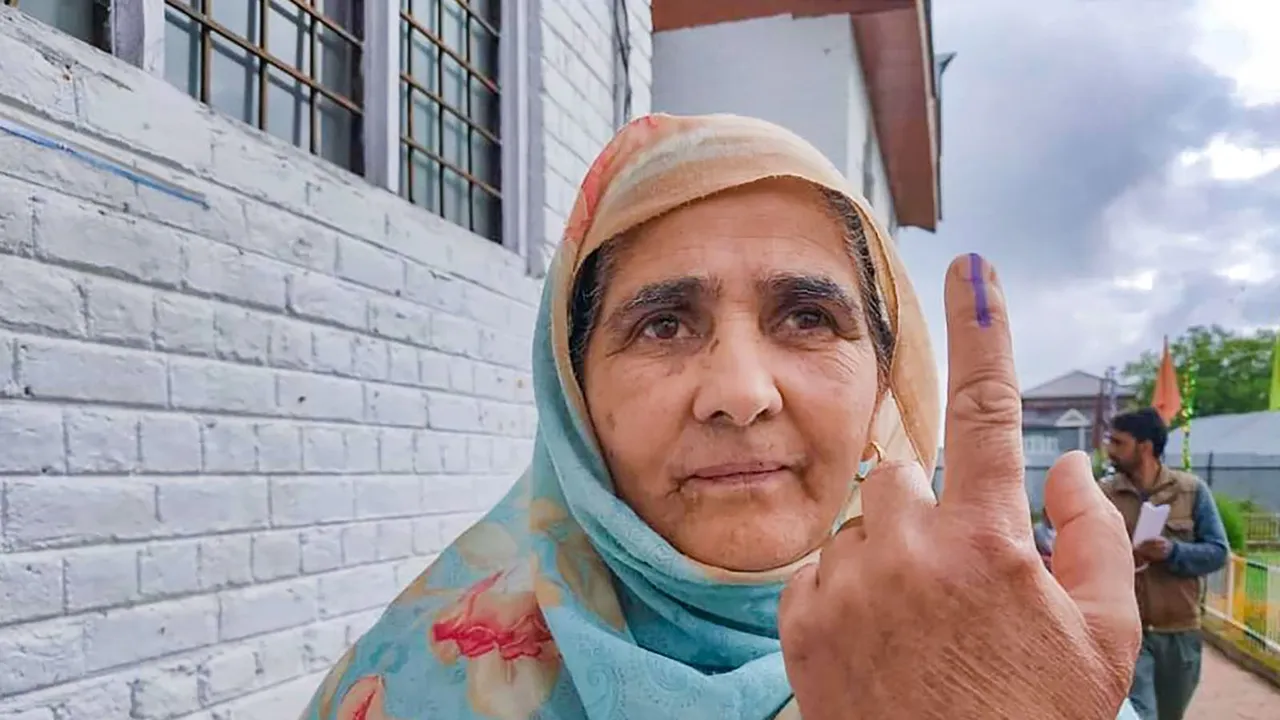 A woman shows her inked finger after casting her vote at a polling booth during the fourth phase of General Elections-2024 in Pulwama, J & K, Monday, May 13, 2024.