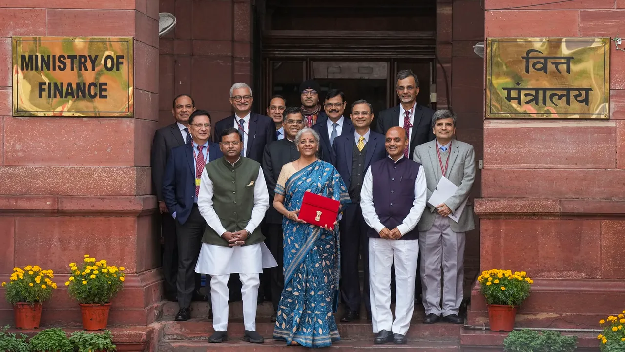 Union Finance Minister Nirmala Sitharaman and other officials poses for photos outside the Finance Ministry, holding a folder-case containing the Interim Budget 2024