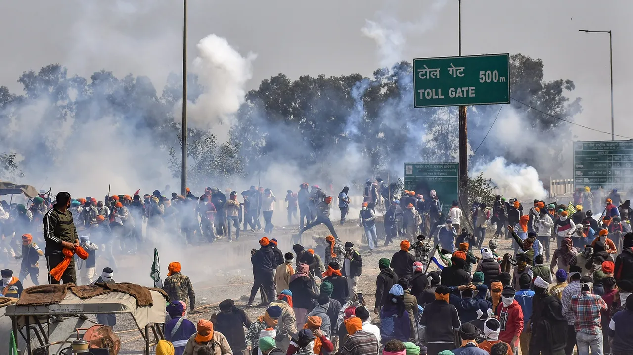 Farmers face tear gas used by the police to disperse them during the second day of their 'Delhi Chalo' march, at the Punjab-Haryana Shambhu border, near Patiala