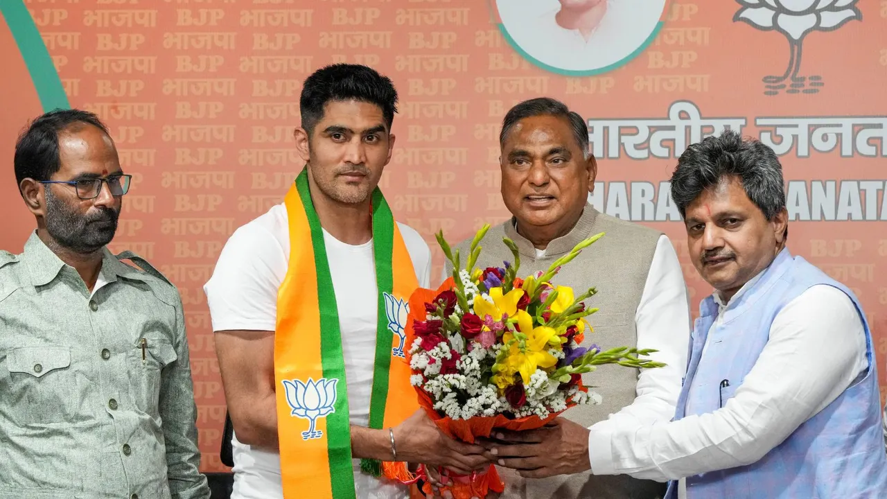 Boxer and former Congress leader Vijender Singh being greeted by BJP leader Ramvir Singh Bidhuri as he joins the party ahead of Lok Sabha elections, at BJP HQ in New Delhi, Wednesday, April 3, 2024