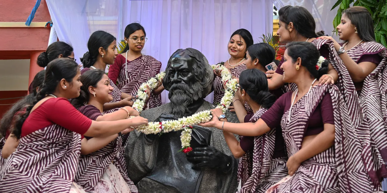 Students of Rabindra Bharati University garland a statue of Nobel laureate poet Rabindranath Tagore on the eve of his birth anniversary, at his ancestral house 'Jorasanko Thakurbari', in Kolkata