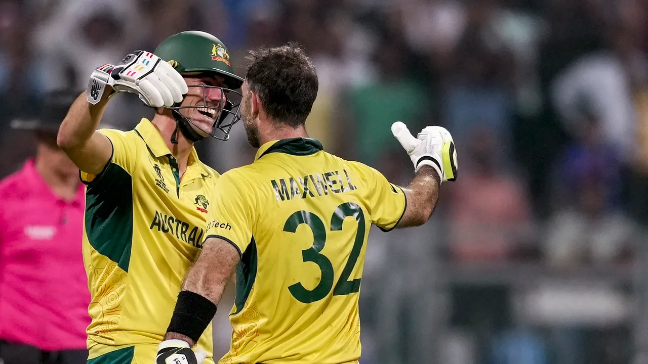 Australia's Glenn Maxwell and Pat Cummins celebrate their victory in the ICC Men's Cricket World Cup 2023 match between Afghanistan and Australia at the Wankhede Stadium, in Mumbai