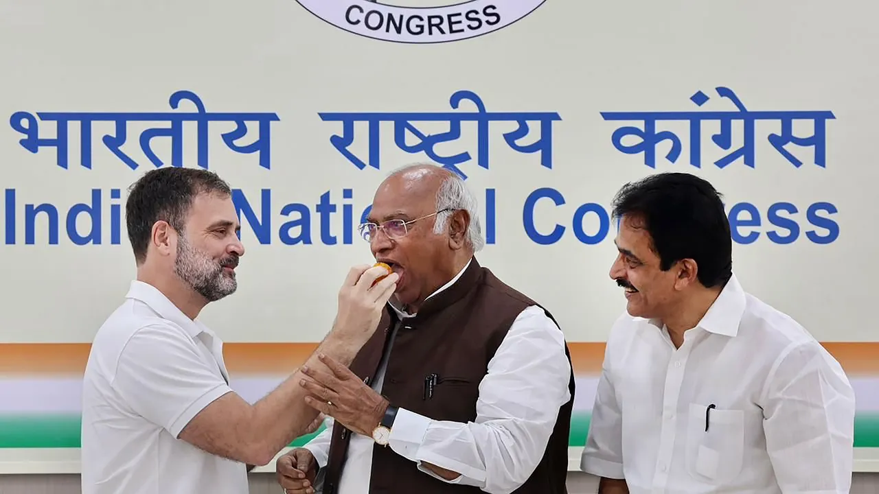 Congress leader Rahul Gandhi offers sweets to party chief Mallikarjun Kharge to celebrate after the Supreme Court stayed his conviction