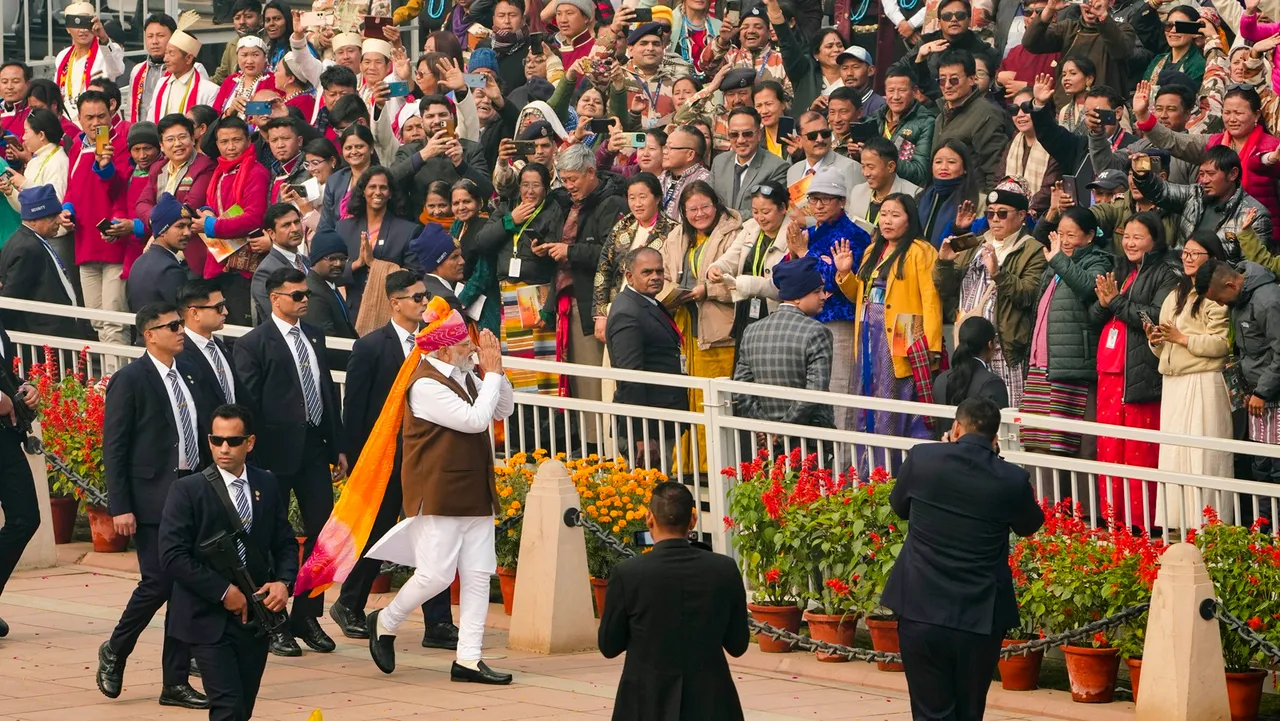 Prime Minister Narendra Modi acknowledges the crowd as he leaves after the 75th Republic Day function