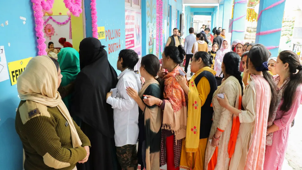 Voters wait in a queue at a polling station to cast their votes for the first phase of Lok Sabha elections, in Doda, Friday, April 19, 2024