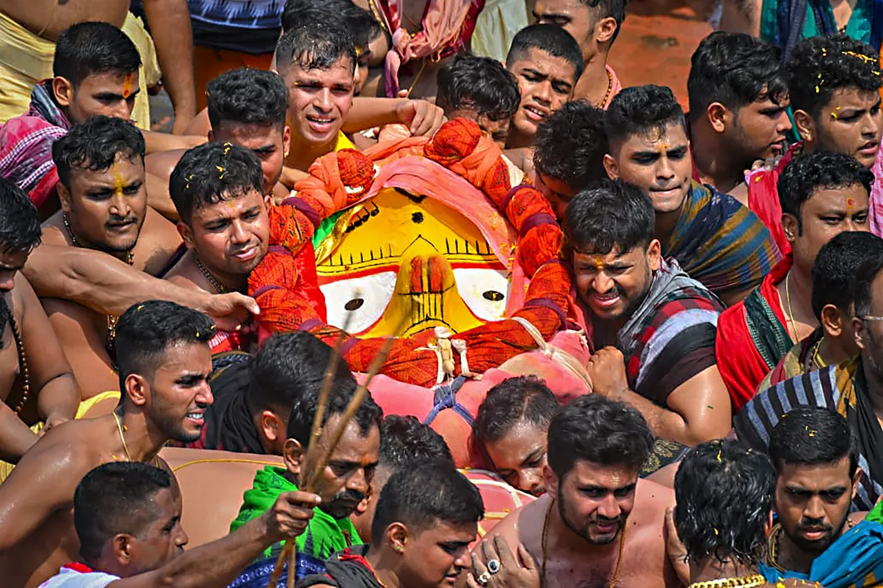 Devotees perform 'Pahandi' ritual during the Rath Yatra festival, in Puri