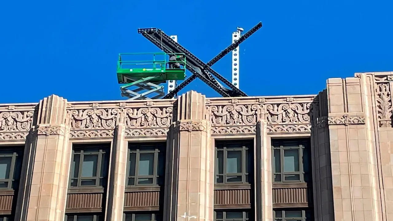 X logo atop twitter building