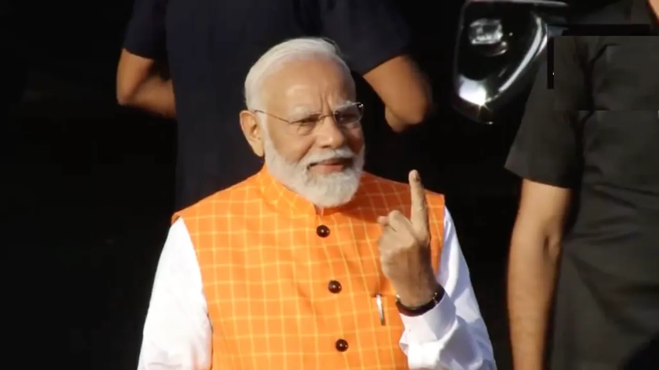 Narendra Modi shows his inked finger after casting his vote at a polling booth in Ahmedabad, Gujarat