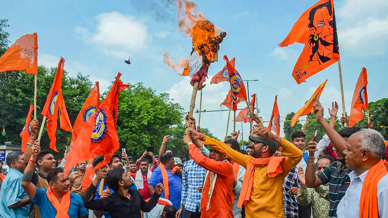 Members of Bajrang Dal burn an effigy during a protest against the violence in Haryana's Nuh district, at GTB Nagar in New Delhi