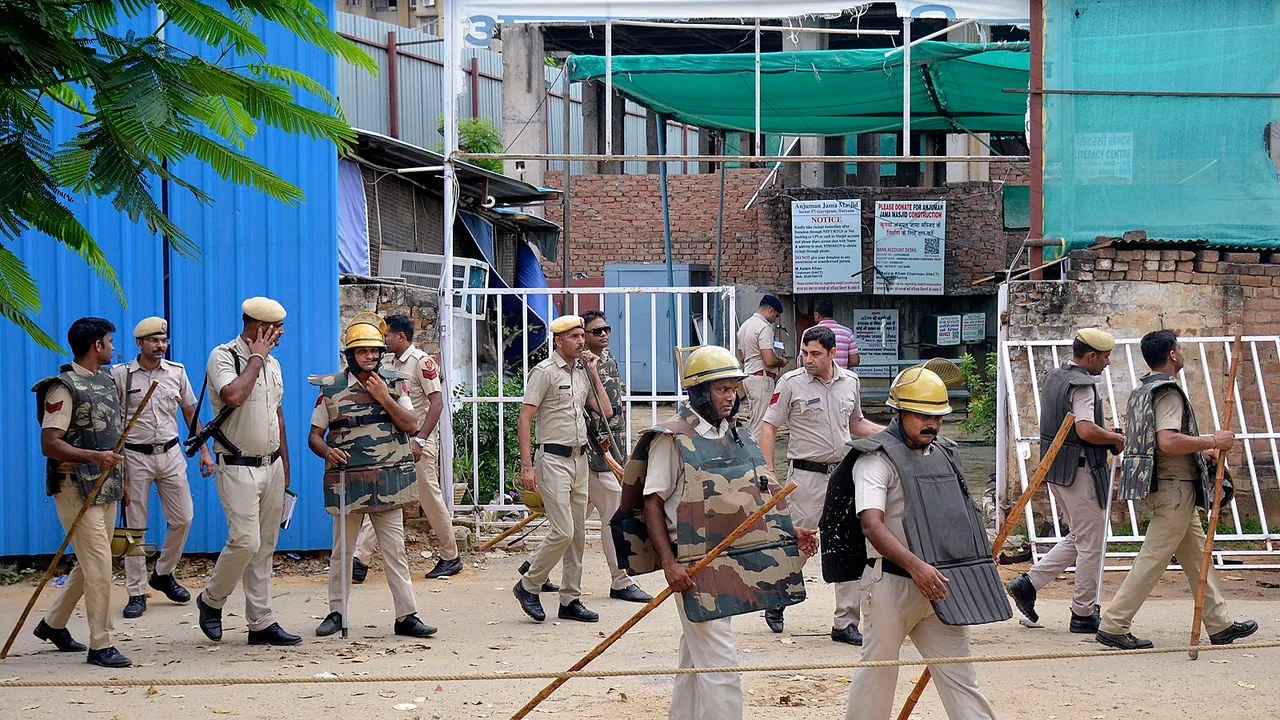 Police personnel outside Anjuman Mosque which was set ablaze in the Sector 57 area, in Gurugram district