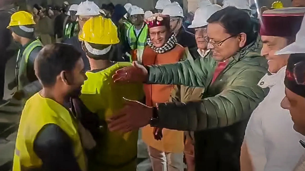 Uttarakhand Chief Minister Pushkar Singh Dhami and Union Minister of State for Road Transport & Highways VK Singh greet rescued workers coming out of the collapsed Silkyara Tunnel, in Uttarkashi district, Tuesday, Nov. 28, 2023.