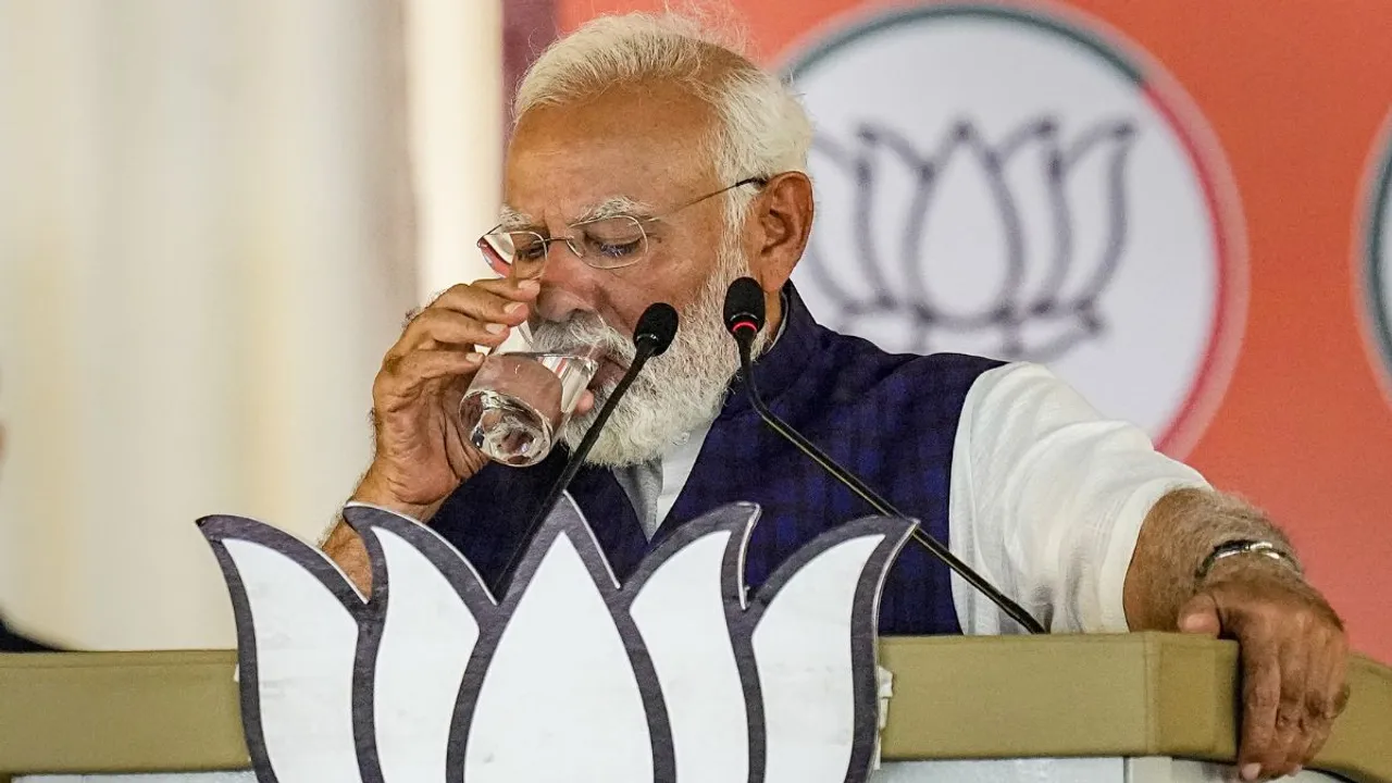Prime Minister Narendra Modi drinks water amid his address during a public meeting ahead of Lok Sabha elections, in Salem, Tamil Nadu, Tuesday, March 19, 2024. 