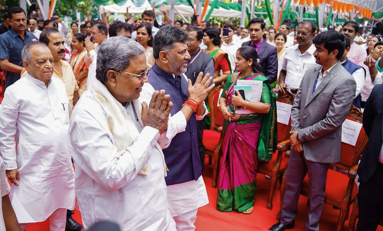 Karnataka Chief Minister Siddaramaiah with Deputy Chief Minister DK Shivakumar greets during the swearing-in ceremony of newly-inducted cabinet ministers at Raj Bhavan