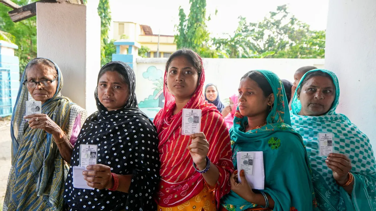 People wait in a queue to cast their votes at a polling booth during the sixth phase of Lok Sabha elections, in Purba Medinipur district, Saturday, May 25, 2024