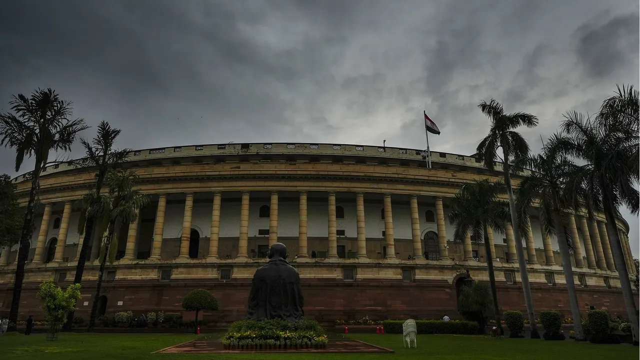 Dark clouds gather over the Parliament House during Monsoon session, in New Delhi