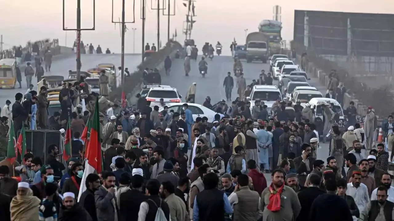 Supporters of Khan's PTI party block the road as they protest against the alleged rigging
