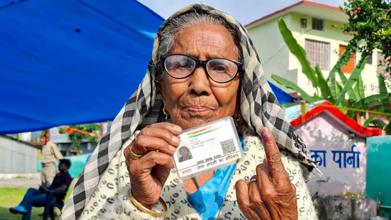 An elderly woman shows her finger marked with indelible ink after casting vote during Uttarakhand Assembly bypolls, in Chamoli district, Wednesday, July 10, 2024.