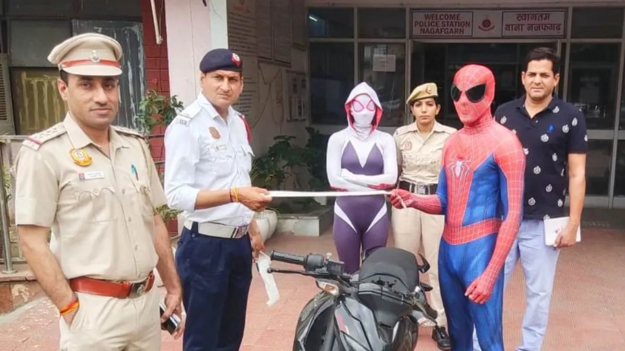 Two people wearing Spiderman costumes held for flouting road rules