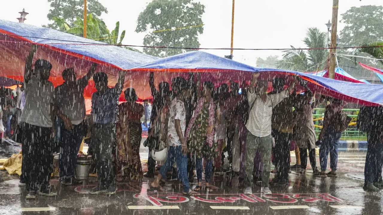 Agitators take cover during rains as junior doctors continue their 'cease work' and sit-in demonstration against the RG Kar Hospital incident, outside Swasthya Bhavan in Kolkata, Friday, Sept. 13, 2024