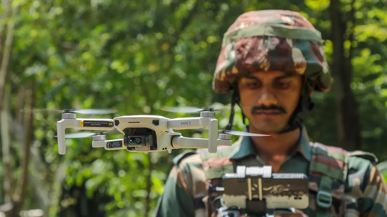 An Indian army soldier operates a drone for surveillance along the Line of Control (LOC) between India and Pakistan border ahead of the Independence Day, in Poonch district