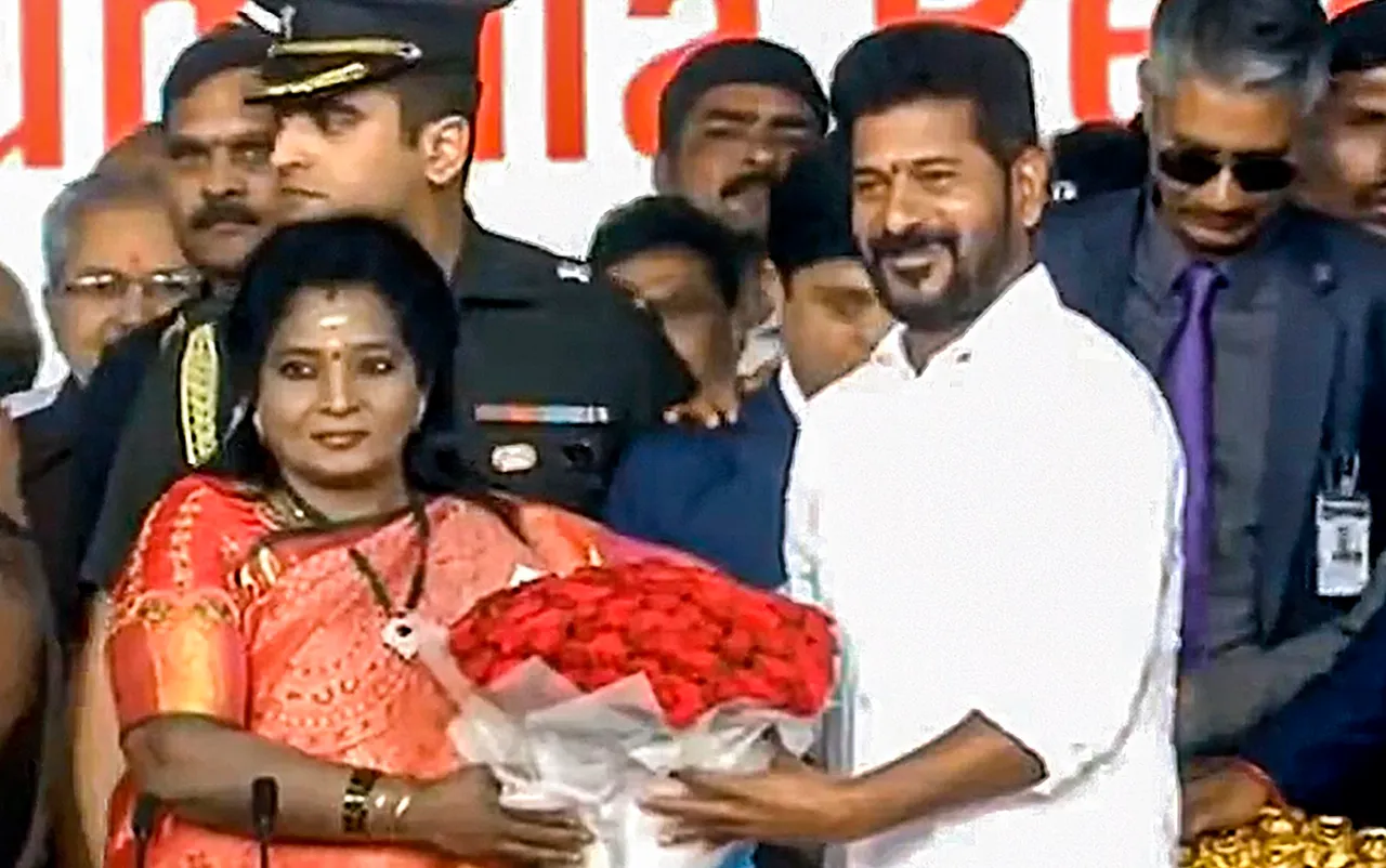 Telangana Governor Tamilisai Soundararajan greets the state's newly sworn-in CM Revanth Reddy after administering oath to him