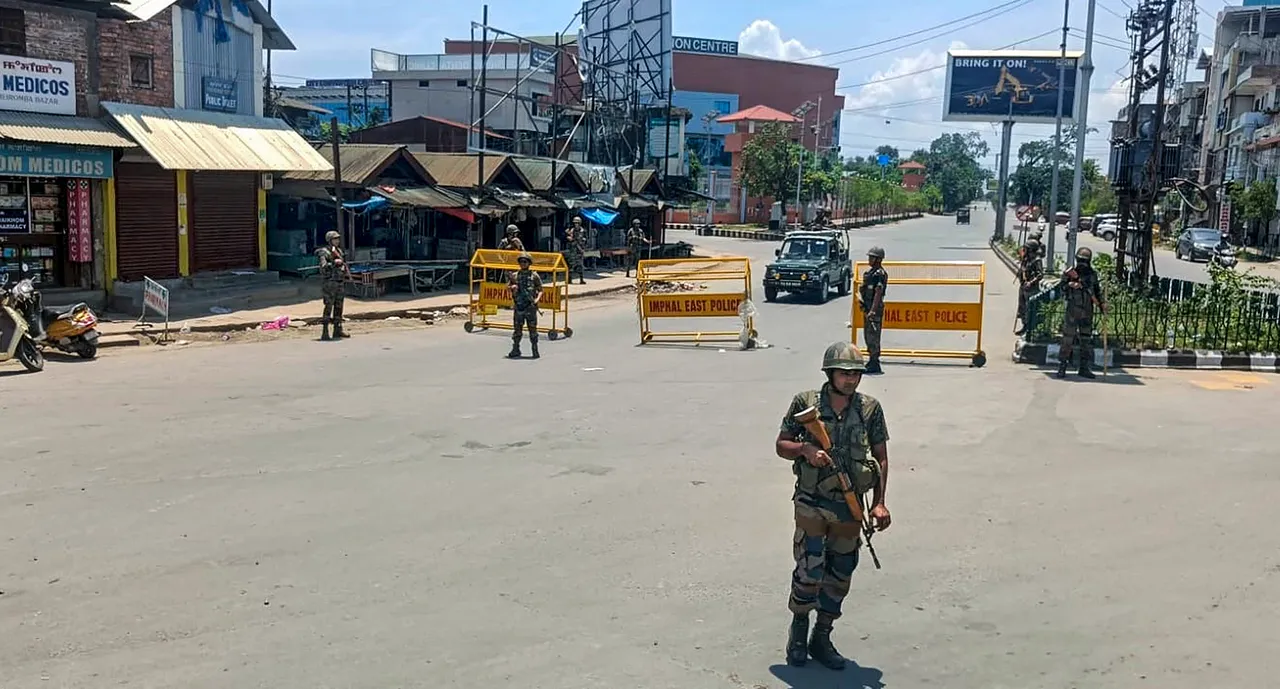 Army personnel stand guard at a checkpoint near City Convention Centre area after three armed men were apprehended by a Mobile Vehicle Check Post (MVCP), in Imphal East district