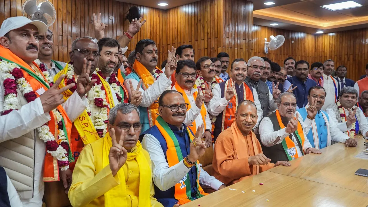 UP Chief Minister Yogi Adityanath, Dy CM Brajesh Pathak and SBSP chief OP Rajbhar flashes victory sign with NDA candidates after they files their nomination papers for the UP Legislative Council polls, in Lucknow