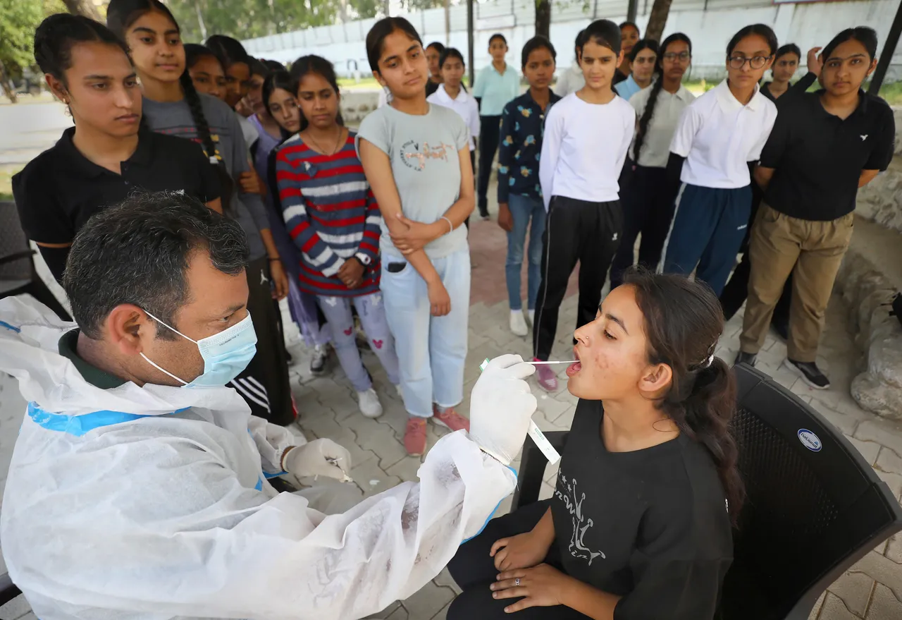 A healthcare worker collects sample of an NCC cadet for Covid-19 test