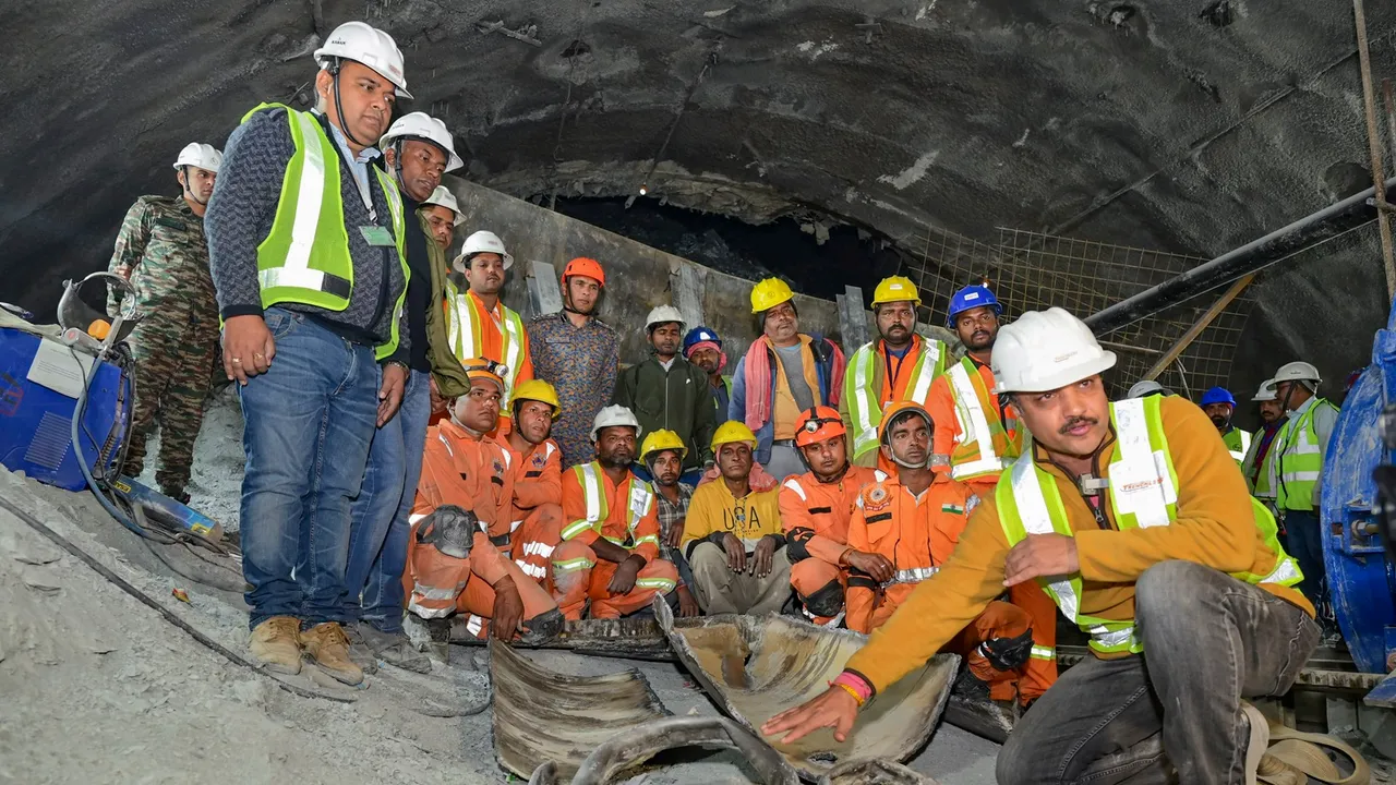 Workers show the part of an auger machine, that was damaged during a drilling through the rubble to extract 41 trapped workers inside the under-construction Silkyara tunnel