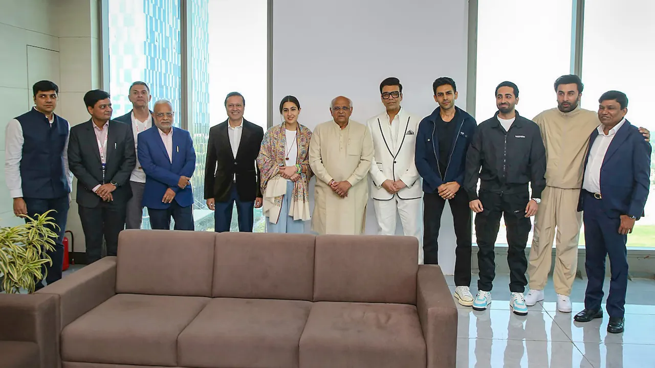 Gujarat Chief Minister Bhupendra Patel poses for group photos with filmmaker Karan Johar and other actors ahead of Filmfare Awards ceremony, in Gandhinagar, Sunday, Jan. 28, 2024