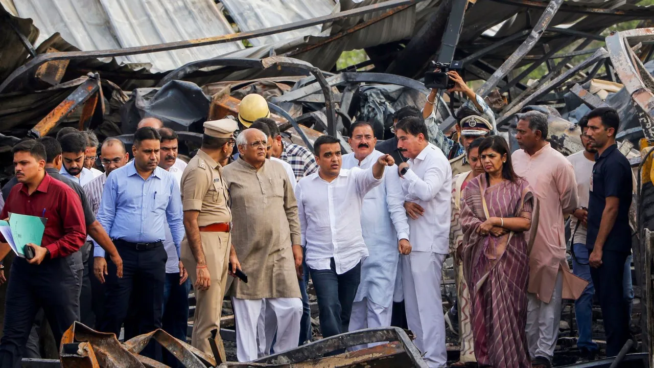 Gujarat Chief Minister Bhupendra Patel with Union Minister of State Harsh Sanghavi and other officials at the game zone site, in Rajkot, Sunday, May 26, 2024