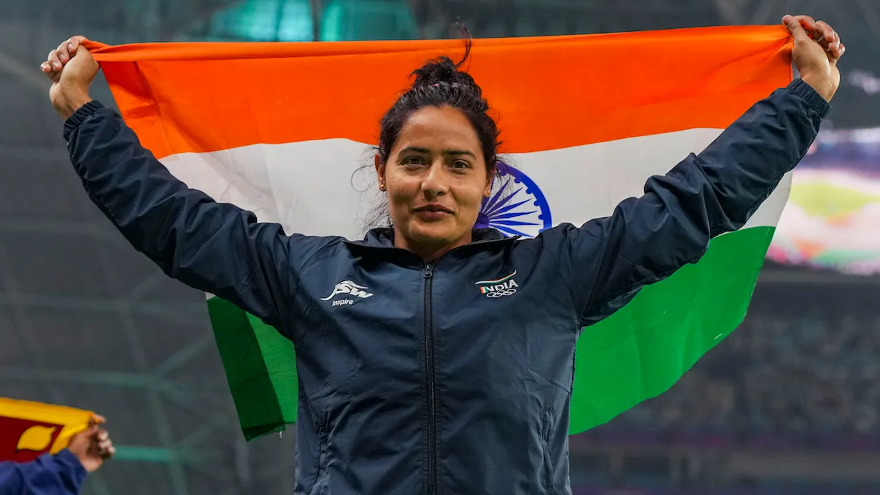 Annu Rani waves the national flag after securing first rank in the Women's Javelin Throw Final event at the 19th Asian Games, in Hangzhou, China, Tuesday, Oct. 3, 2023