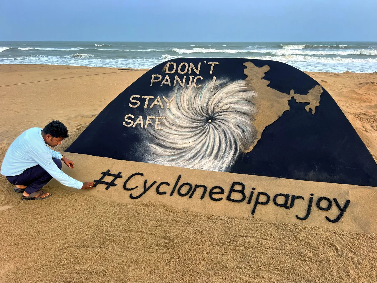 Sand artist Sudarsan Pattnaik creates a sand sculpture on Cyclone Biparjoy with a message ‘Don’t panic, stay safe’