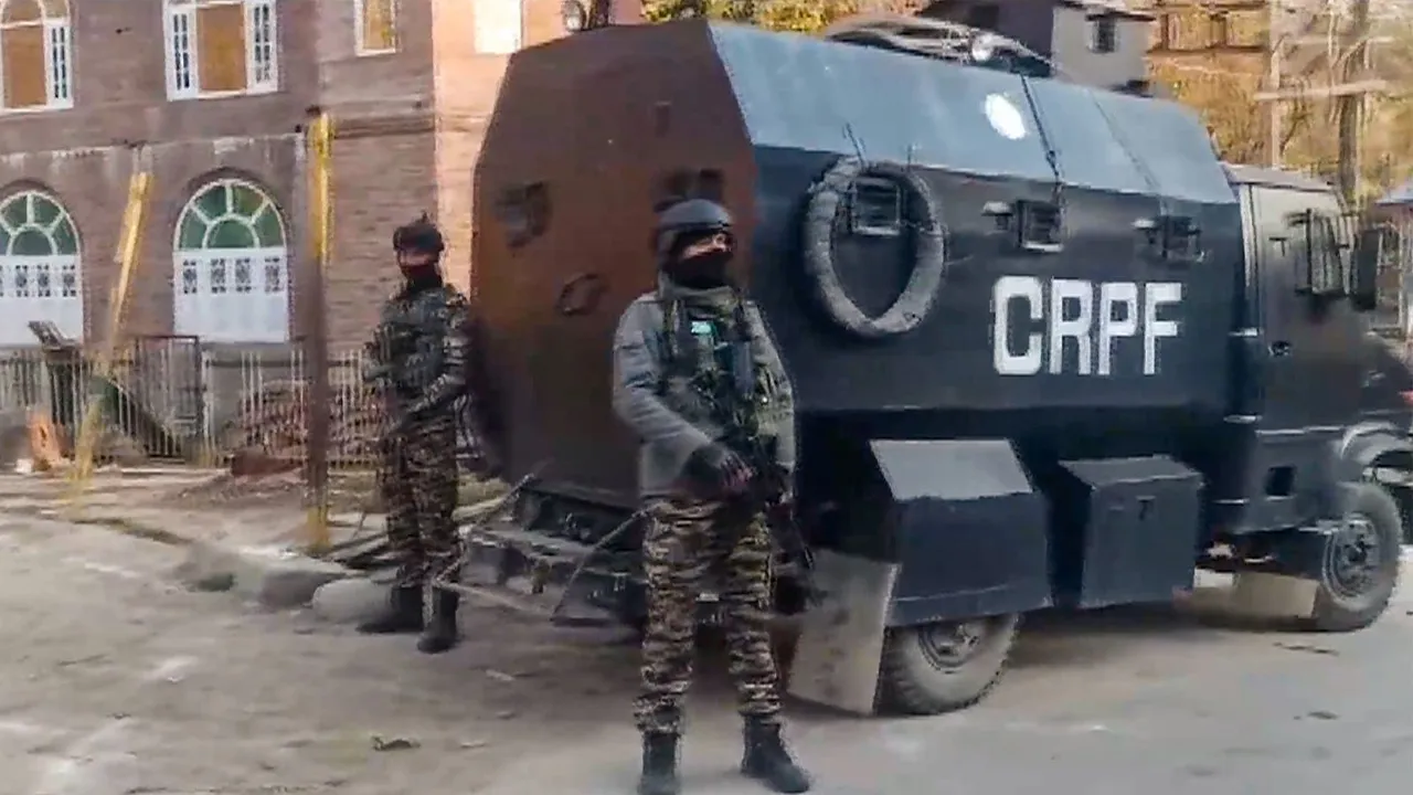 Security personnel stand guard after an encounter broke out between security forces and terrorists, in Pulwama district, Thursday, April 11, 2024