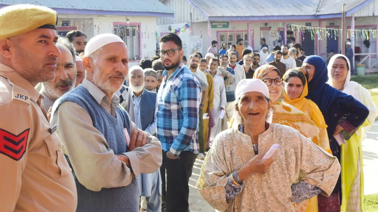 Voters stand in a queue to cast votes during the first phase of Jammu and Kashmir Assembly elections, in Pulwama district