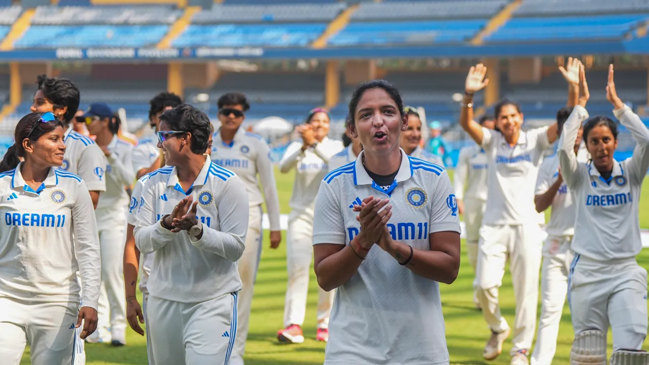 Indian captain Harmanpreet Kaur with teammates celebrates after India won the one-off Test cricket match against Australia