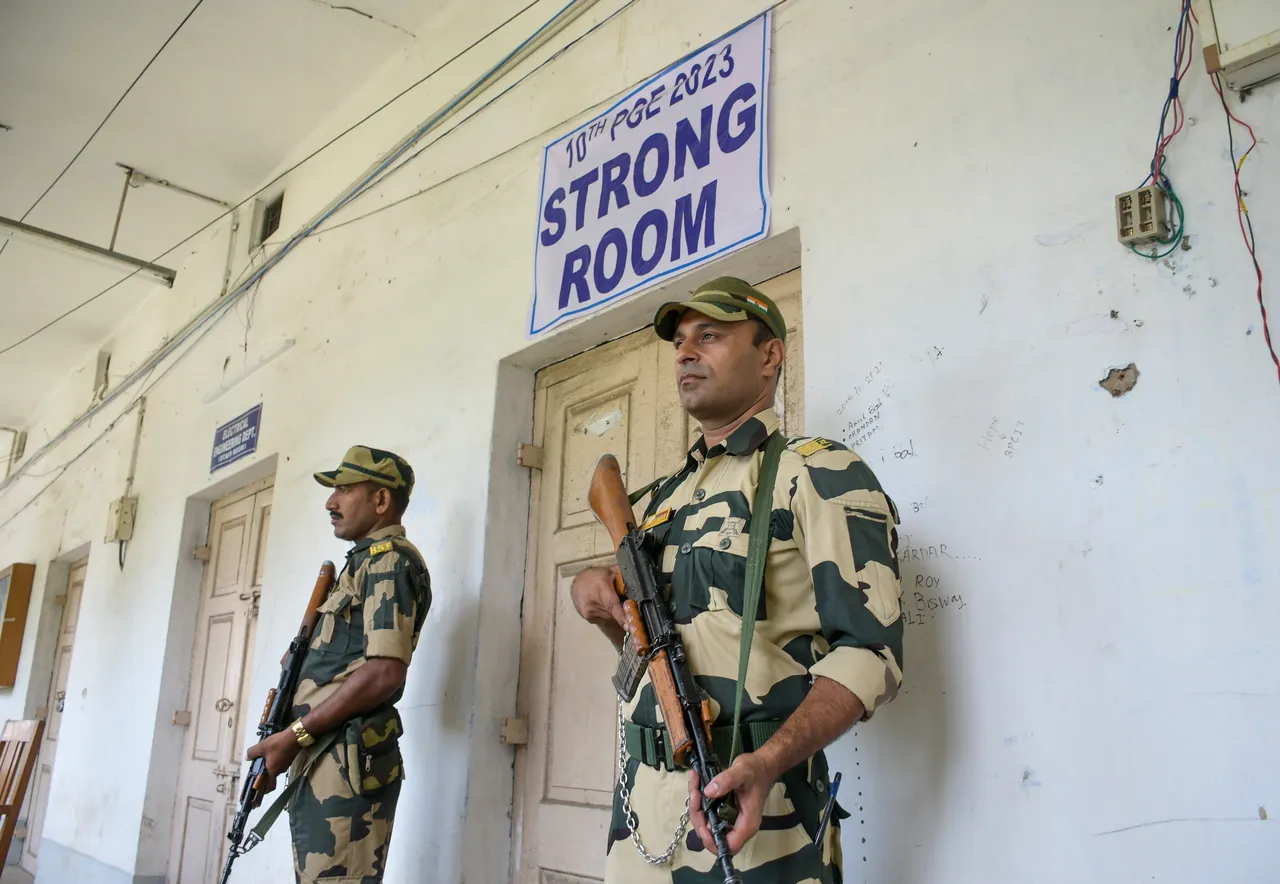 Security personnel stand guard outside a strong room