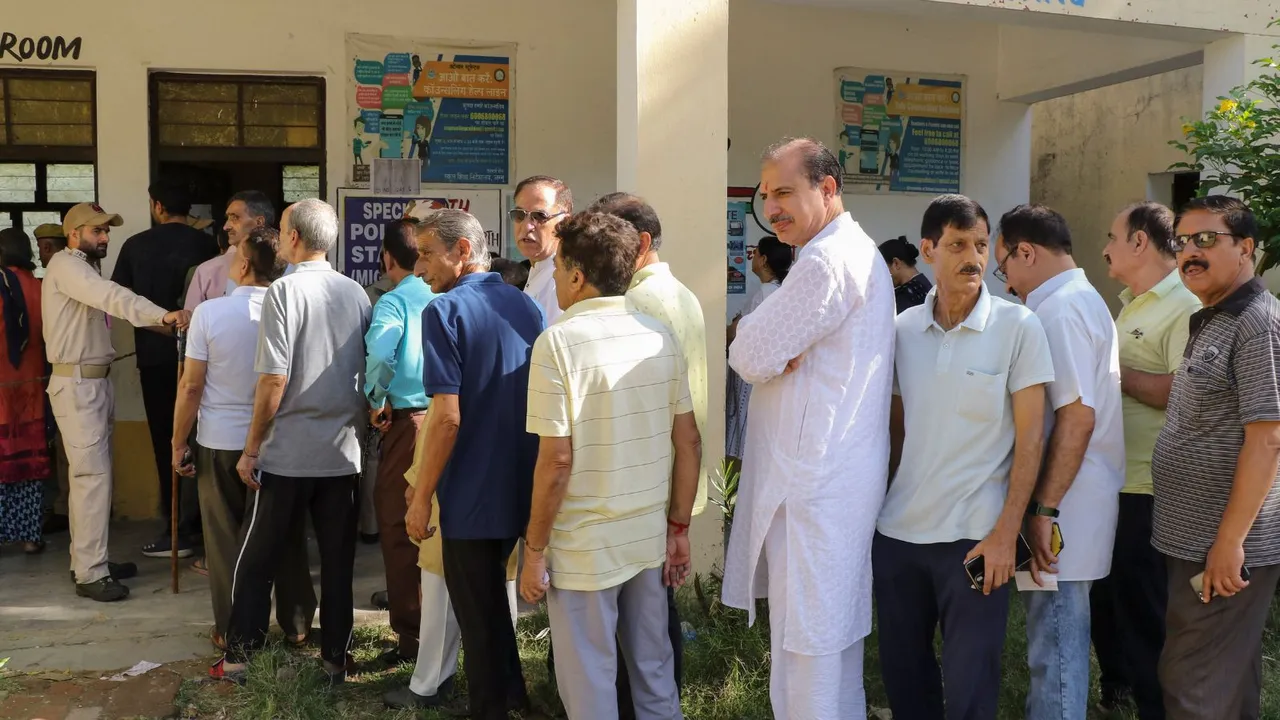Kashmiri Pandits stand in a queue to cast their vote during the fourth phase of Lok Sabha elections, at Roopnagar in Jammu district, Monday, May 13, 2024