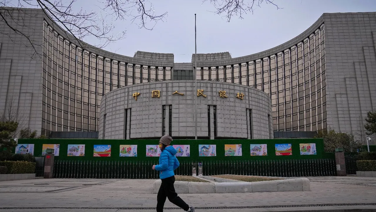 A woman jogs past China's central bank, or the People's Bank of China in Beijing