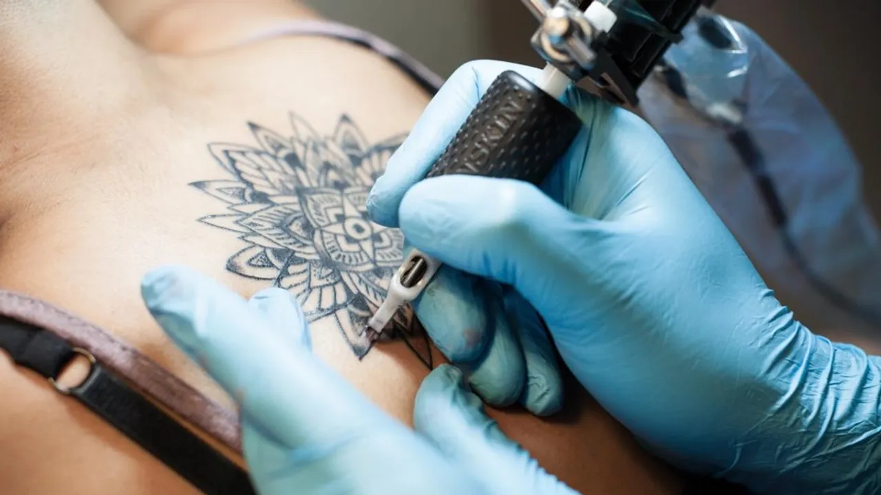 lady getting a tattoo on her back