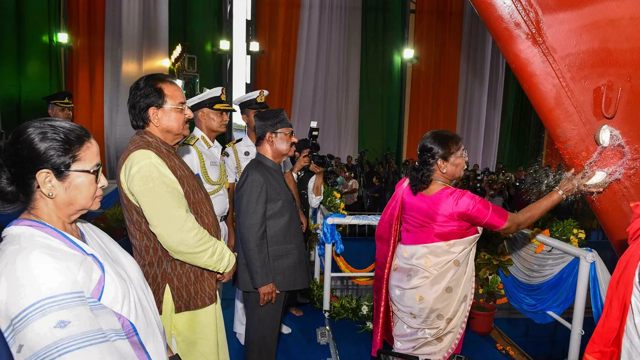 President Droupadi Murmu breaks a coconut during the launch ceremony of Vindhyagiri, the sixth ship of project 17A of Indian Navy, in Kolkata, Thursday