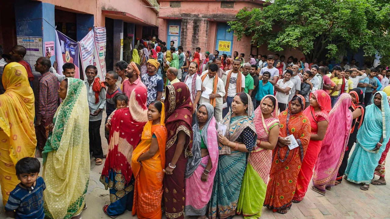 Voters wait in queues outside a polling station during the third phase of Lok Sabha polls, in Khagaria, Tuesday, May 7, 2024