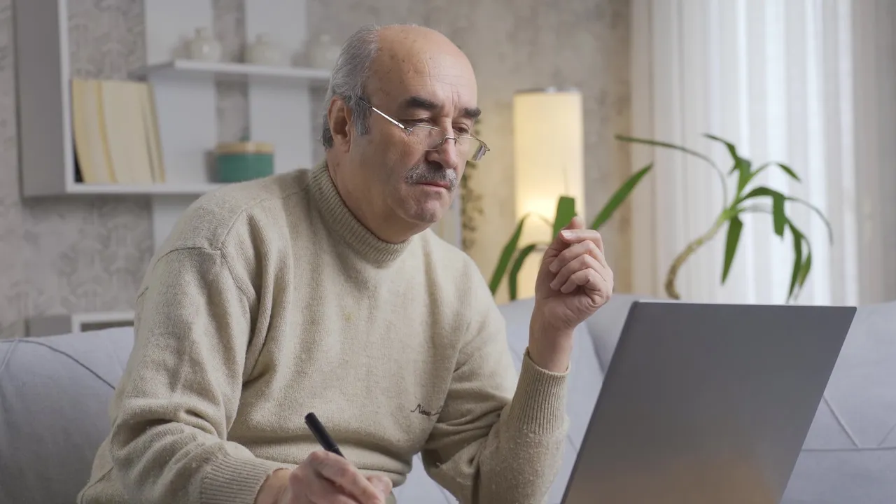 stressed-and-thoughtful-old-man-doing-business-on-computer-old-man-thoughtful-and-worried-while-doing-his-work-on-laptop-at-home