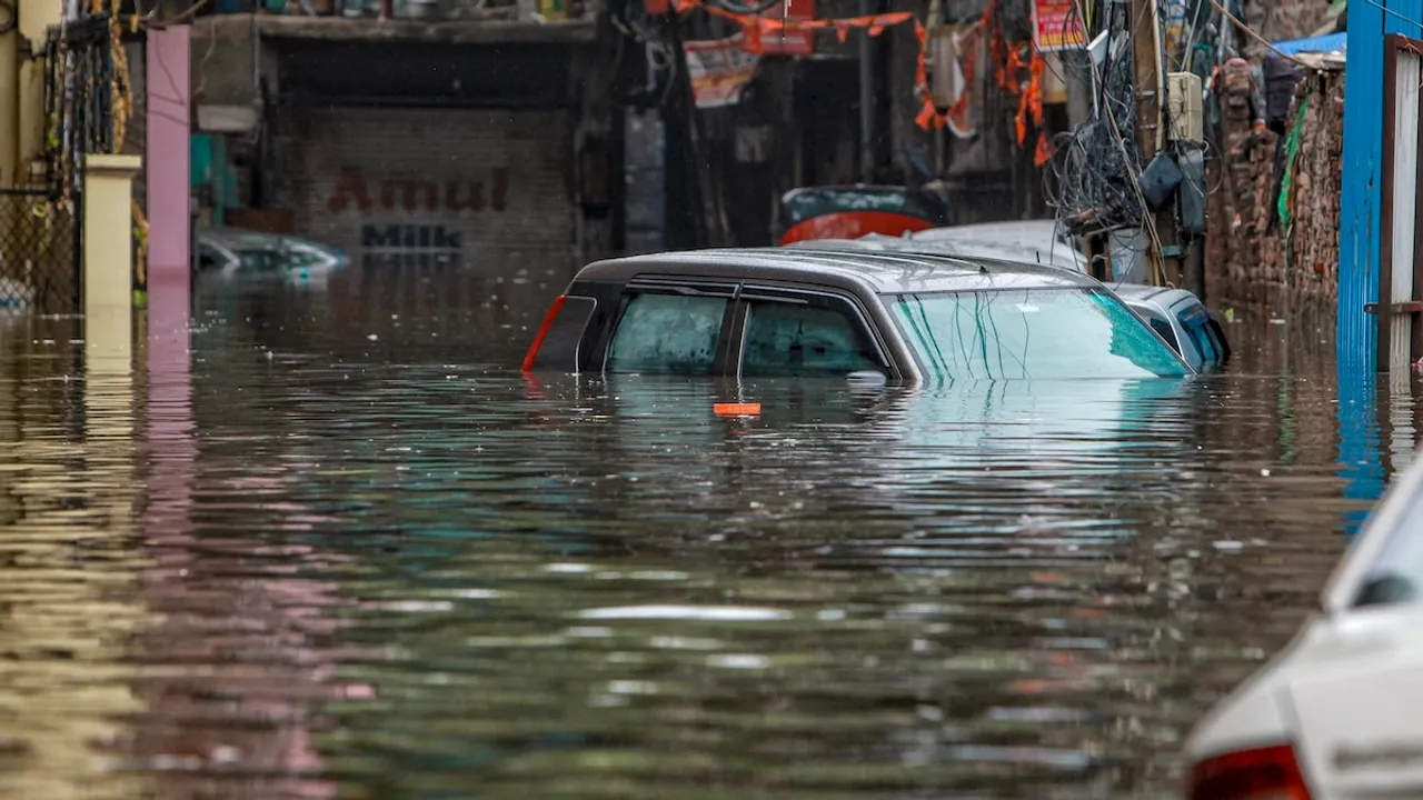 Vehicles are submerged at a waterlogged road near Sarai Kale Khan area after rain, in New Delhi, Friday, June 28, 2024.