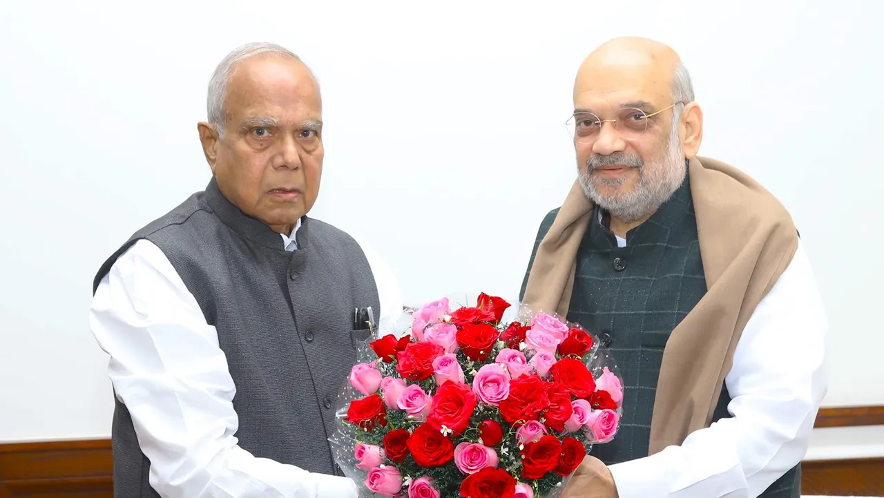 Punjab Governor Banwarilal Purohit presents a flower bouquet to Union Home Minister Amit Shah during a meeting