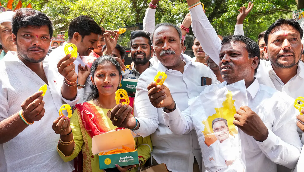 Supporters of Siddaramaiah celebrate outside his residence