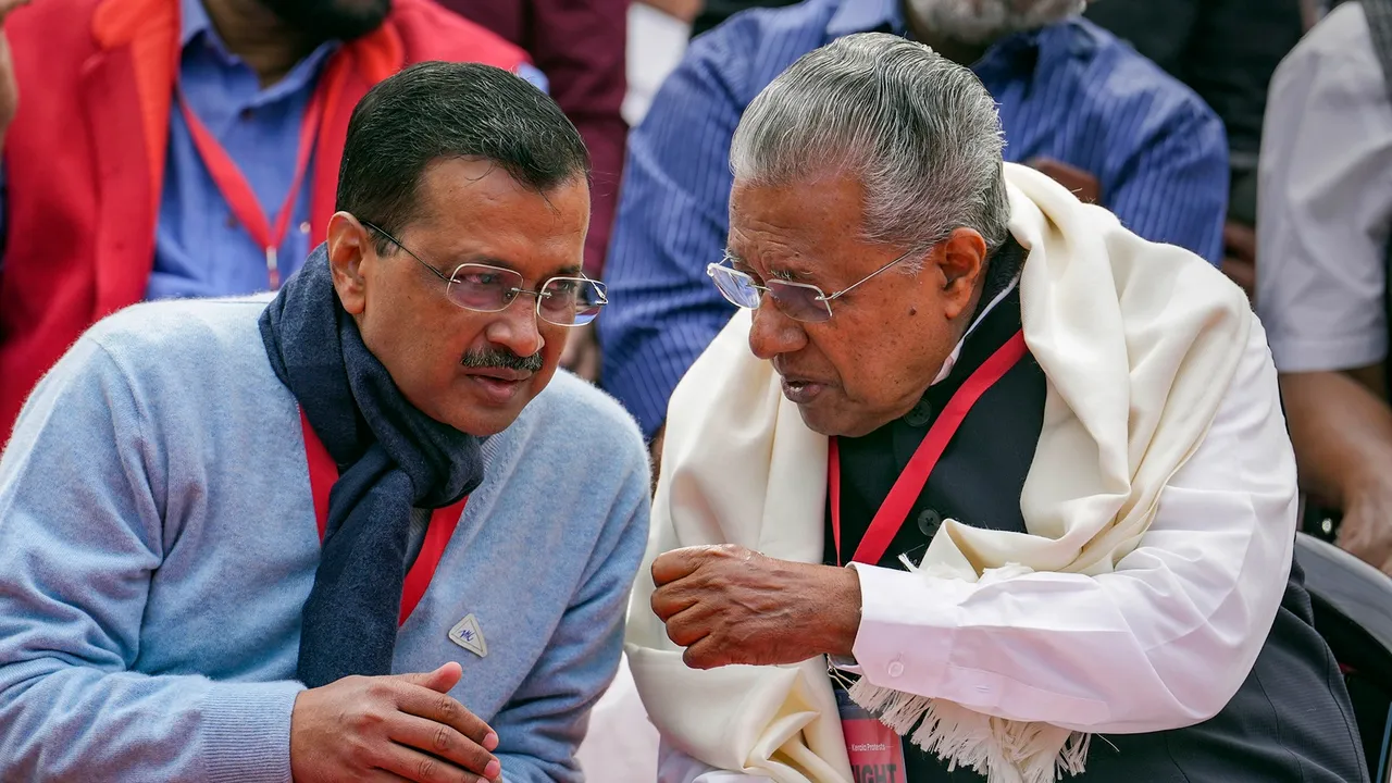 Delhi Chief Minister Arvind Kejriwal interacts with Kerala Chief Minister Pinarayi Vijayan during LDF's protest against the BJP-led Centre