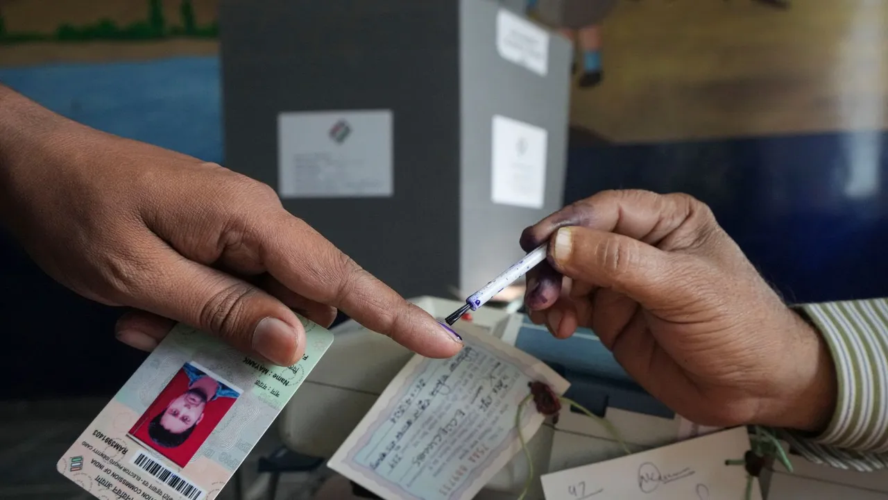 A voter gets her finger marked with indelible ink during voting for the 2nd phase of Lok Sabha elections, in Meerut, Friday, April 26, 2024