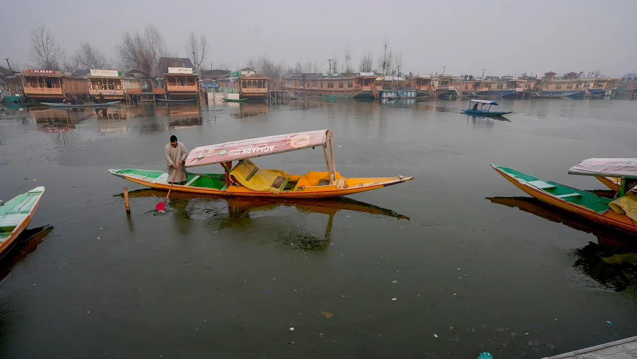 A boatman during a cold morning at the Dal Lake in Srinagar